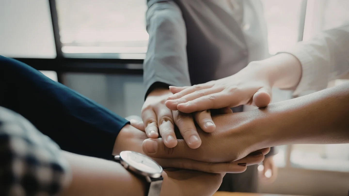 Multiple hands stacked on top of eachother