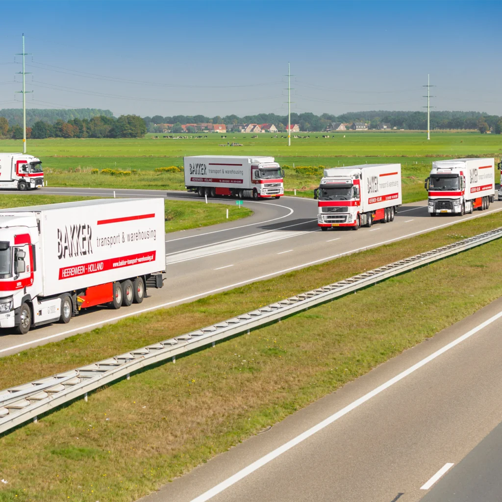 Multiple of the same trucks driving down the highway