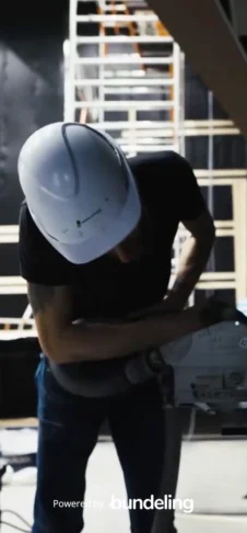A man wearing a hard hat doing construction work