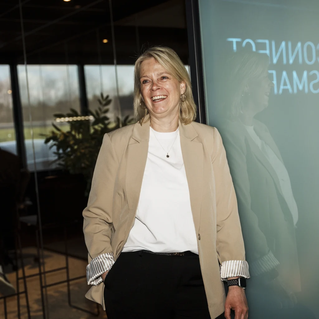 Laughing mature woman leaning against glass.