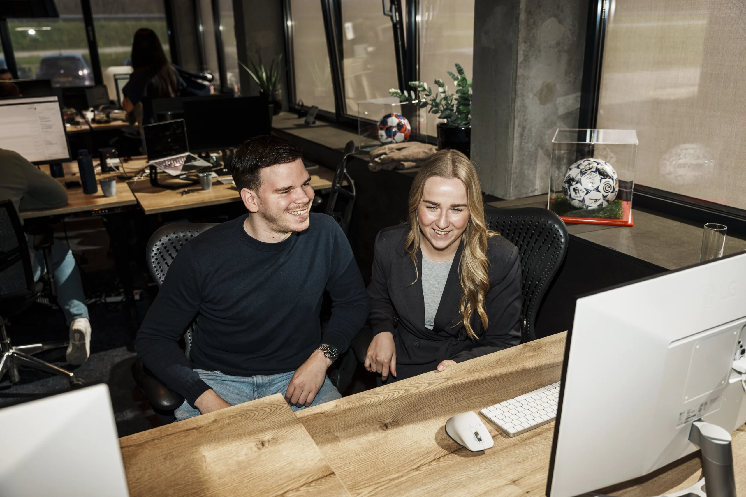 Man and woman collaborating in a office setting.