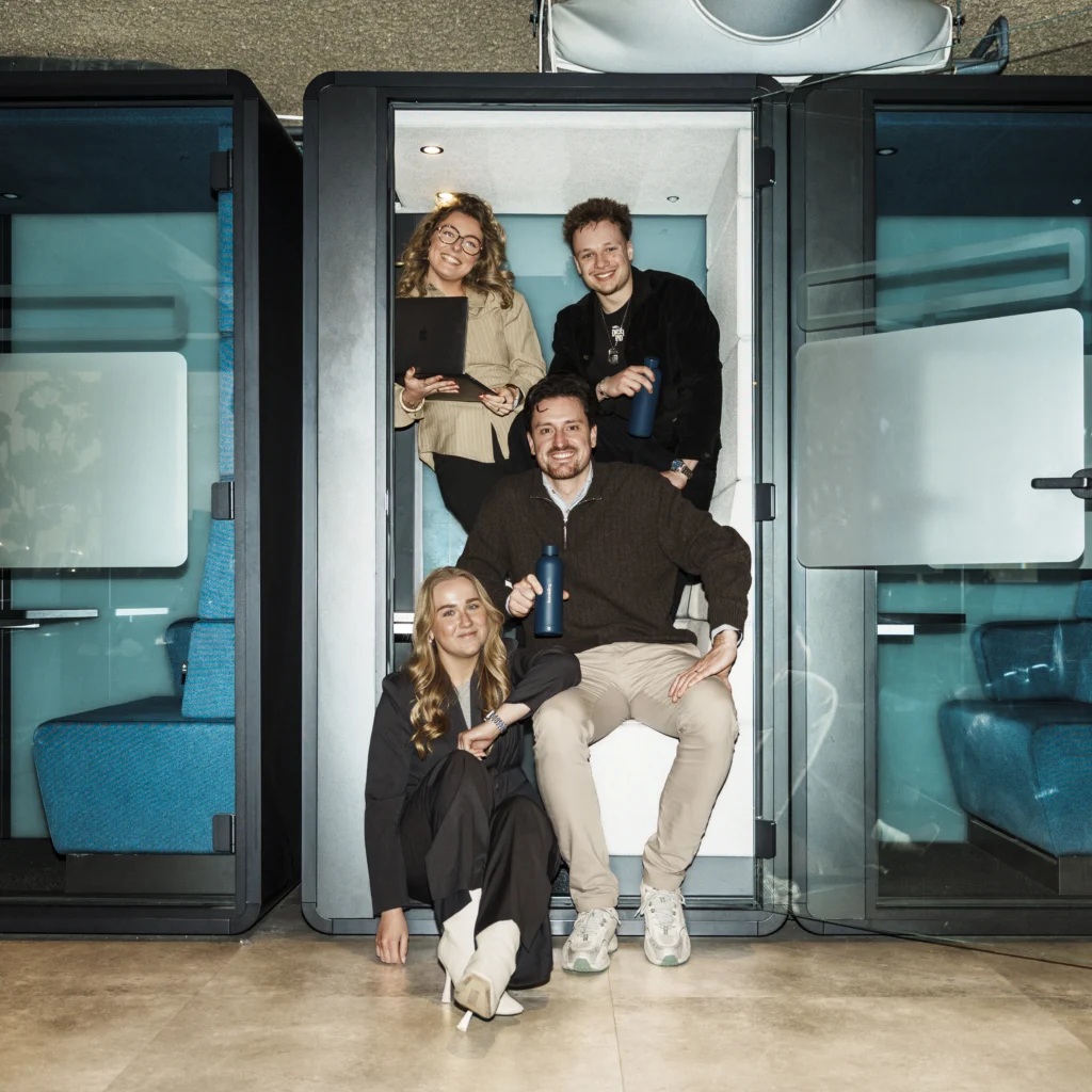 Young team laughing in a small space.
